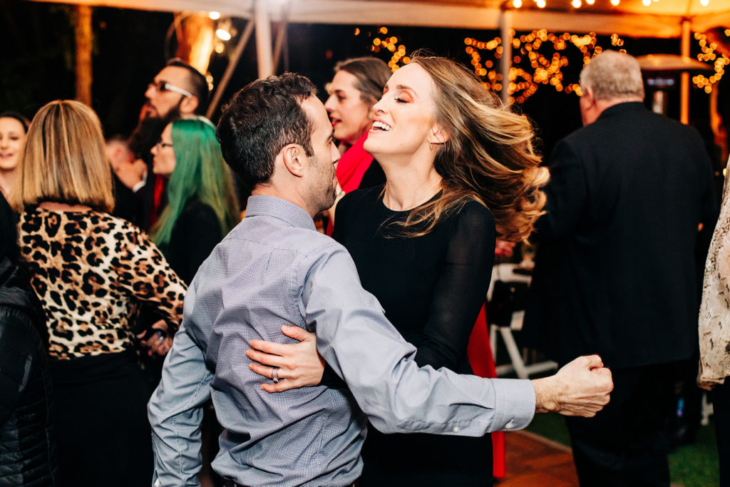 Hartley Botanica wedding photography; guests hugging while dancing at reception