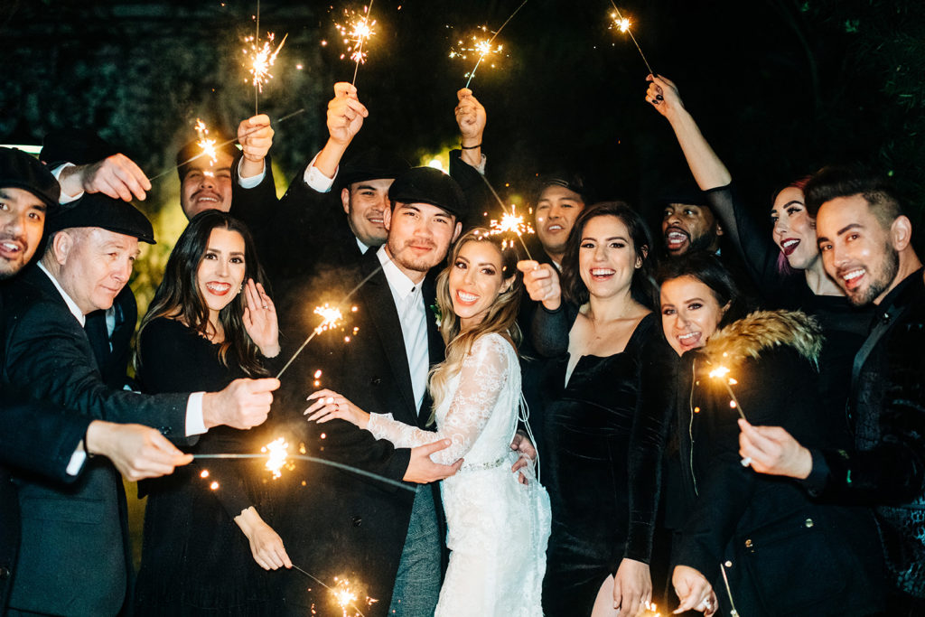 Hartley Botanica wedding photography; bride and groom smiling with guests during sparkler exit