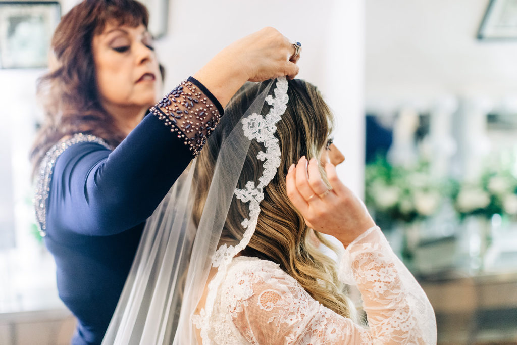 Hartley Botanica wedding photography; bride getting her veil pinned in place