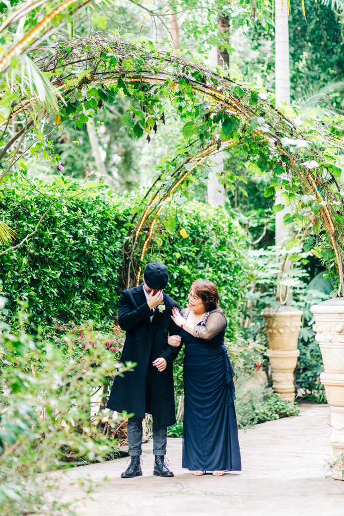 Hartley Botanica wedding photography; groom and mother wiping tears at ceremony