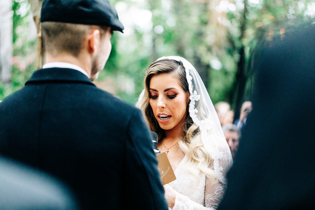 Hartley Botanica wedding photography; bride reads vows at outdoor wedding ceremony