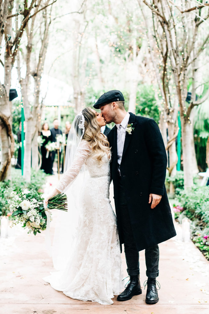 Hartley Botanica wedding photography; bride and groom kiss on the aisle