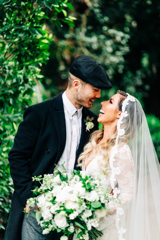 Hartley Botanica wedding photography; bride and groom look at each other laughing after ceremony