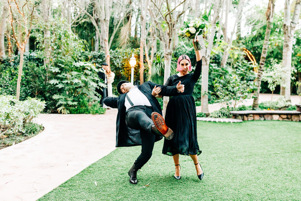 Hartley Botanica wedding photography; bridesmaid and groomsmen dancing into wedding reception outdoors