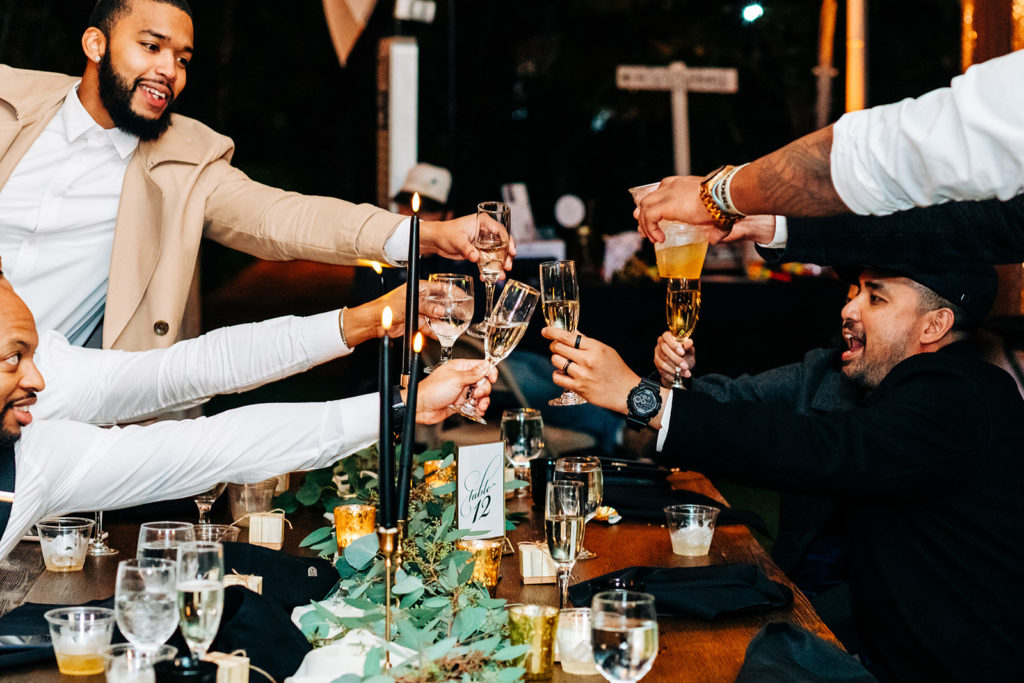 Hartley Botanica wedding photography; groomsmen toasting champagne at wedding reception after speeches