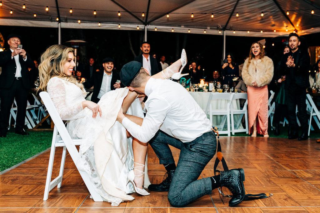 Hartley Botanica wedding photography; groom taking off brides garter