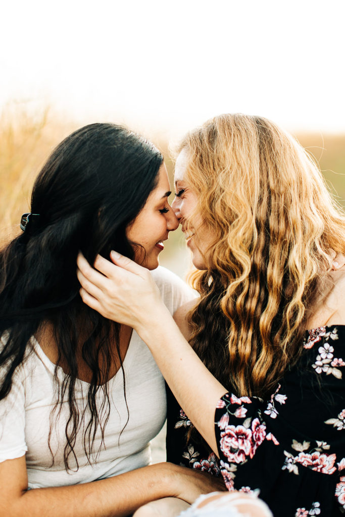 LGBTQ+ wedding photographer; a woman gently holds her girlfriends face