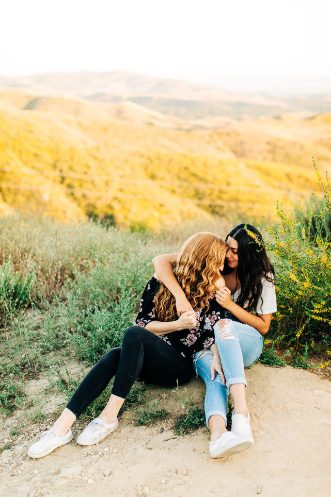 LGBTQ+ wedding photographer; two women holding each other lovingly