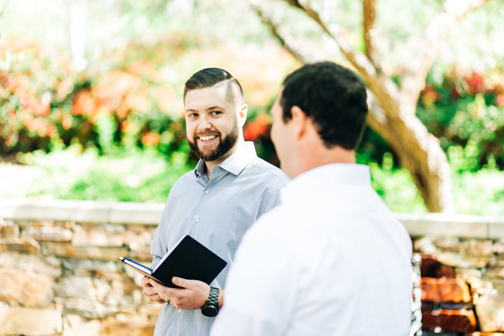 officiant smiling at the groom at an outdoor wedding; orange county elopement photographer