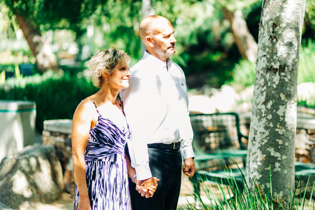 family members at an outdoor wedding watching the ceremony; orange county elopement photographer