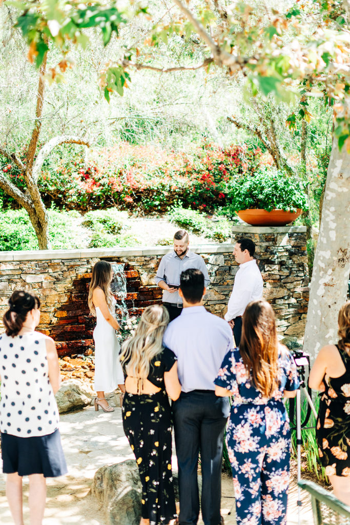 outdoor wedding ceremony in front of a fountain at an outdoor wedding; orange county elopement photographer