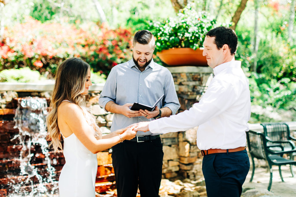 bride and groom exchanging rings on their wedding day; orange county elopement photographer