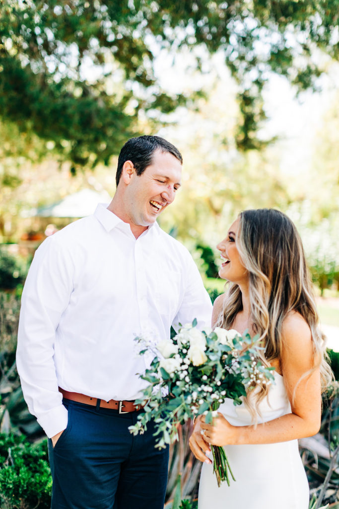 bride and groom laughing on their wedding day; orange county elopement photographer