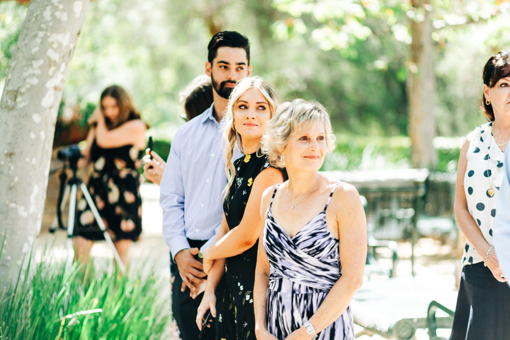 family watching the bride walk down the aisle at an outdoor wedding; orange county elopement photographer