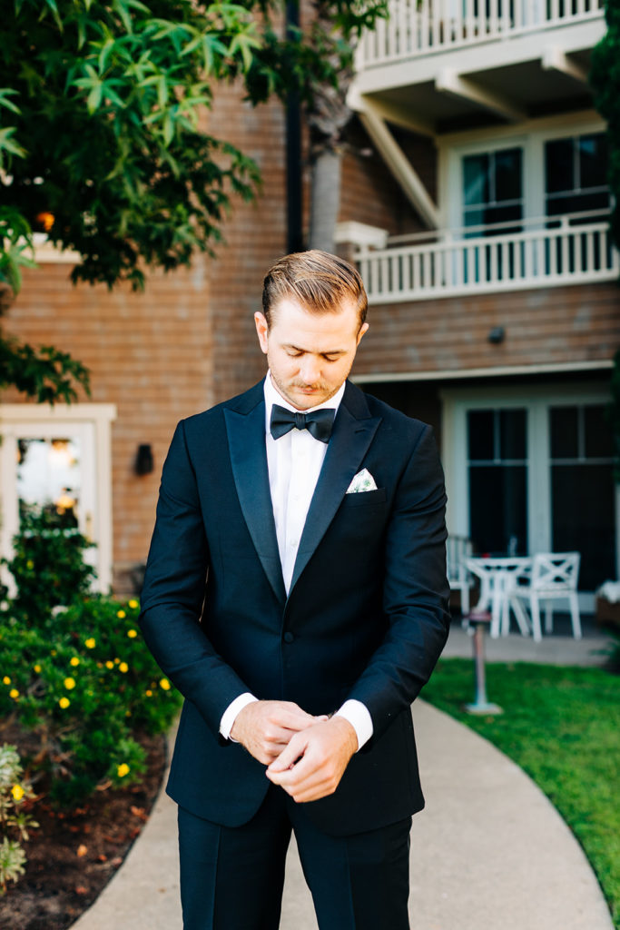 Crystal Cove Micro Wedding in Orange County; groom fixing his suit jacket on his wedding day