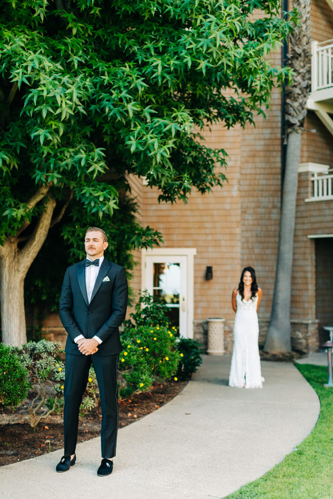 Crystal Cove Micro Wedding in Orange County; groom waiting for his bride to tap him on the shoulder