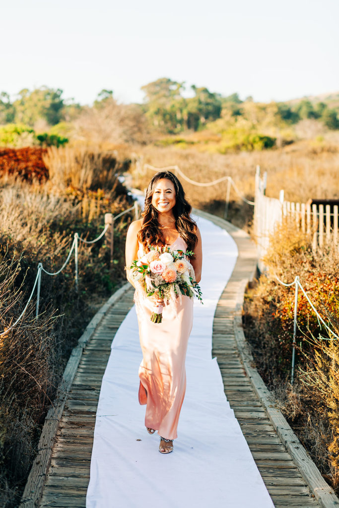 Crystal Cove Micro Wedding in Orange County; bridesmaid walking down the aisle