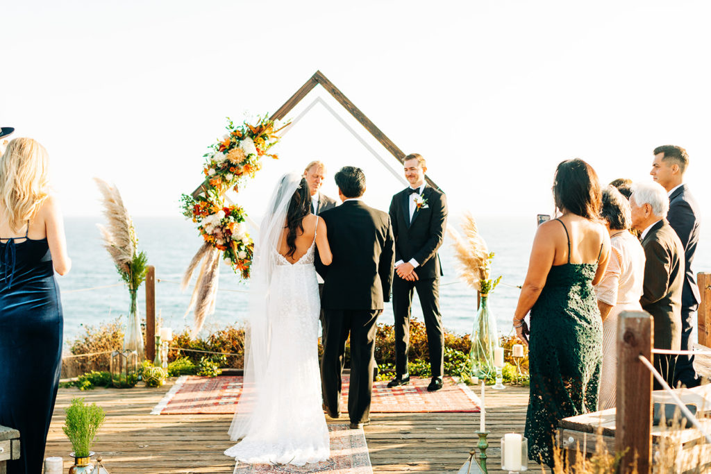 Crystal Cove Micro Wedding in Orange County; bride and her father meet the groom at their wedding