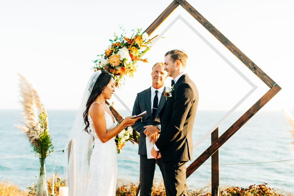 Crystal Cove Micro Wedding in Orange County; bride reading her vows to the groom at their micro wedding in orange county