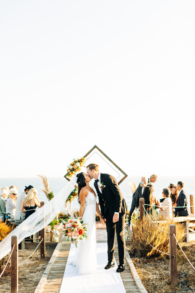 Crystal Cove Micro Wedding in Orange County; bride and groom kissing after their wedding