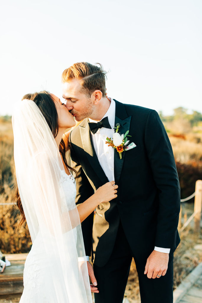 Crystal Cove Micro Wedding in Orange County; portrait of a bride and groom kissing at their wedding