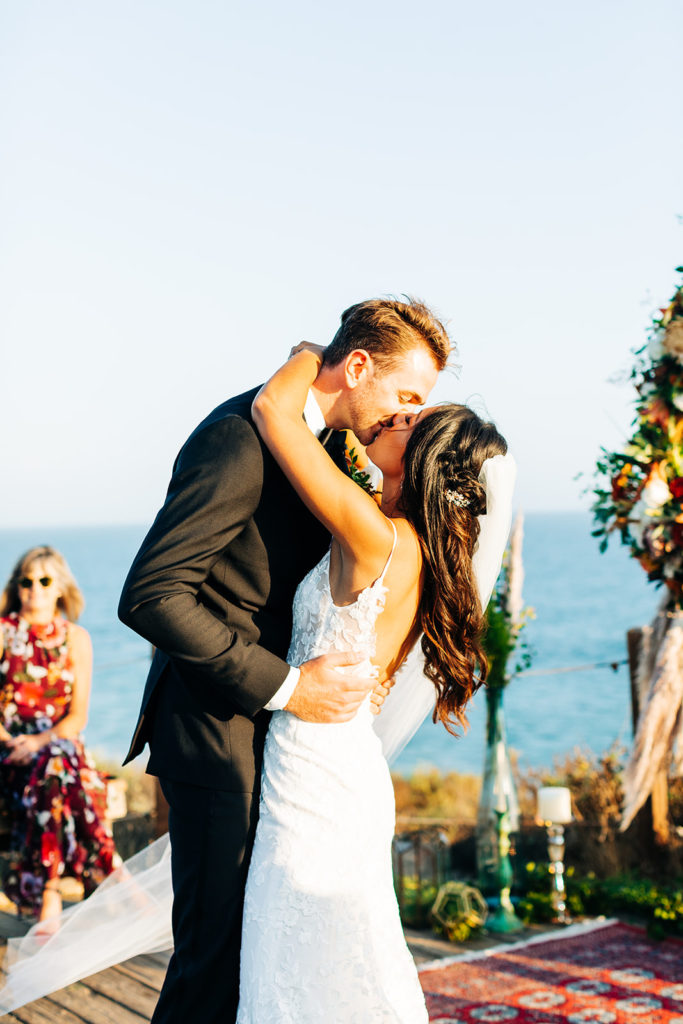 Crystal Cove Micro Wedding in Orange County; bride and groom kissing during their first dance at their micro wedding