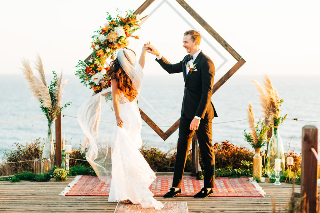 Crystal Cove Micro Wedding in Orange County; bride being spun by the groom