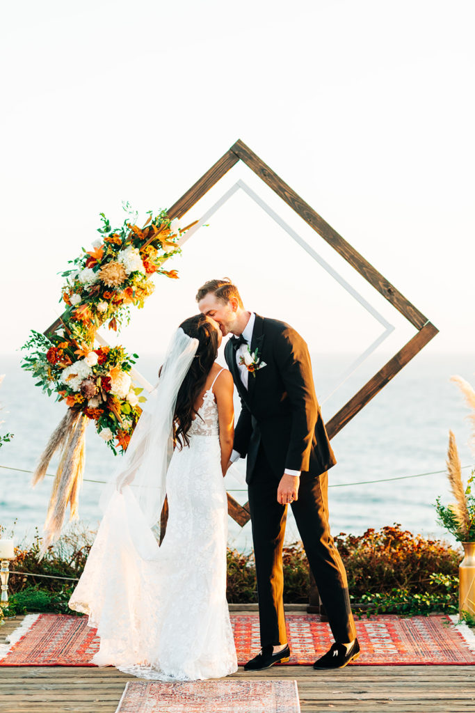 Crystal Cove Micro Wedding in Orange County; bride and groom kissing at their micro wedding in orange county