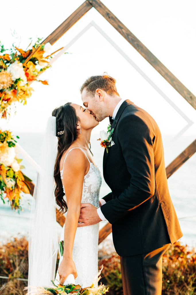 Crystal Cove Micro Wedding in Orange County; close up shot of bride and groom kissing on their wedding day