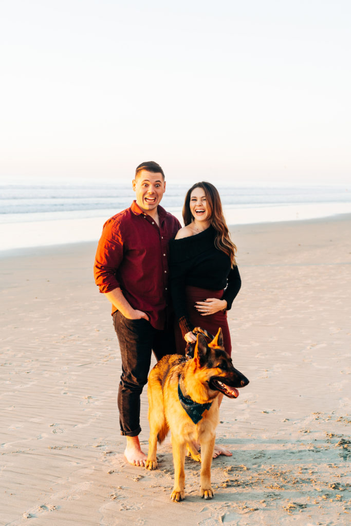 black's beach engagement photos; san diego wedding photographer; a couple and their dog making silly faces at the camera, they are at the beach