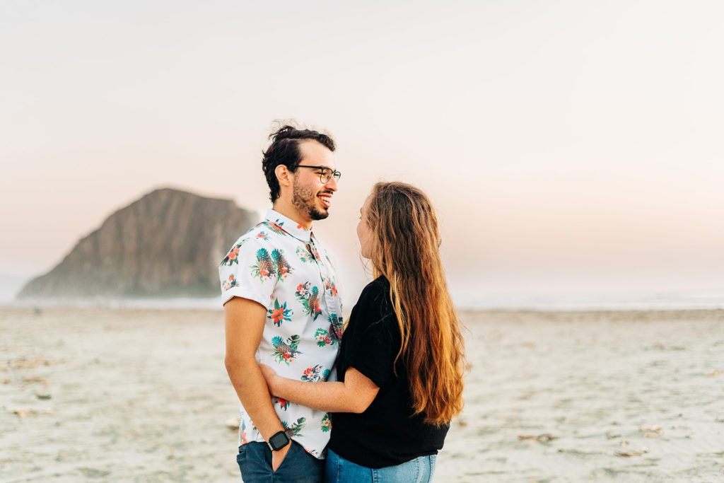 Sunset Engagement Photos at Morro Bay, morro bay wedding photographer; a man and woman hugging on the beach in Morro Bay, california