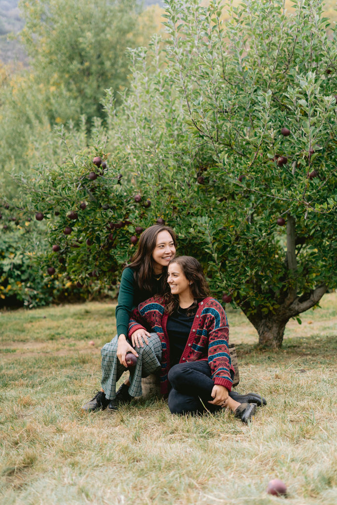 san diego wedding photographer; a lesbian couple taking engagement photos at an apple picking farm
