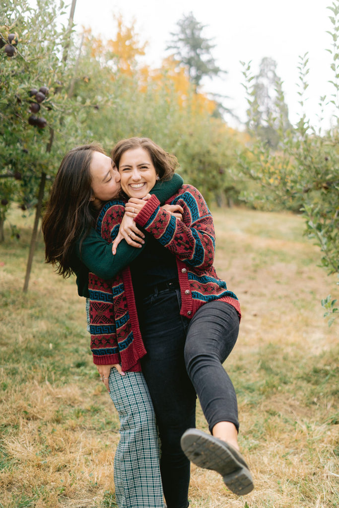 san diego wedding photographer; a lesbian couple taking engagement photos at an apple picking farm