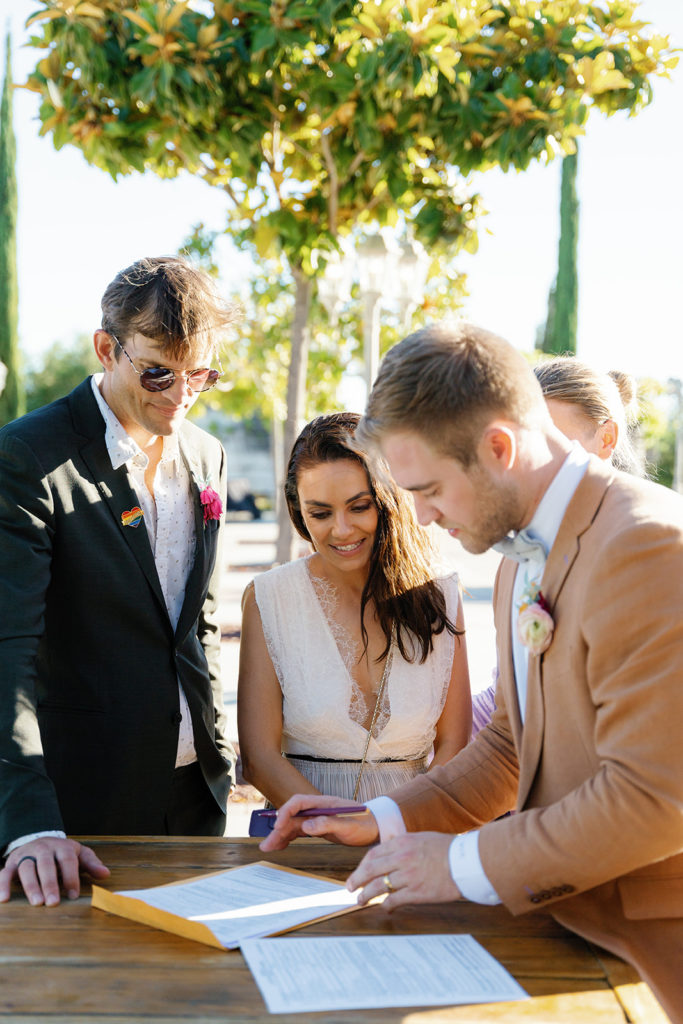 Ashton Kutcher and Mila Kunis sign the marriage license for PK & Mike at their wedding; gay wedding in temecula at mount palomar winery