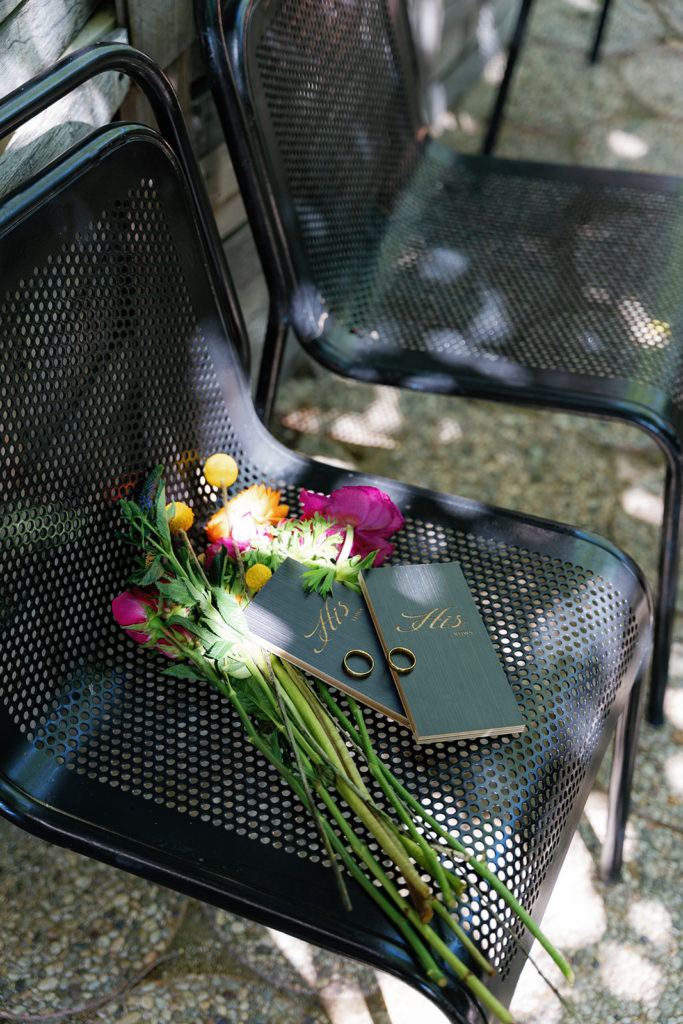 his and his vow books surrounded by flowers; gay wedding in temecula at mount palomar winery