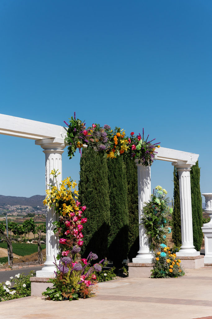 floral arch for a wedding day, the flowers are very colorful; gay wedding in temecula at mount palomar winery