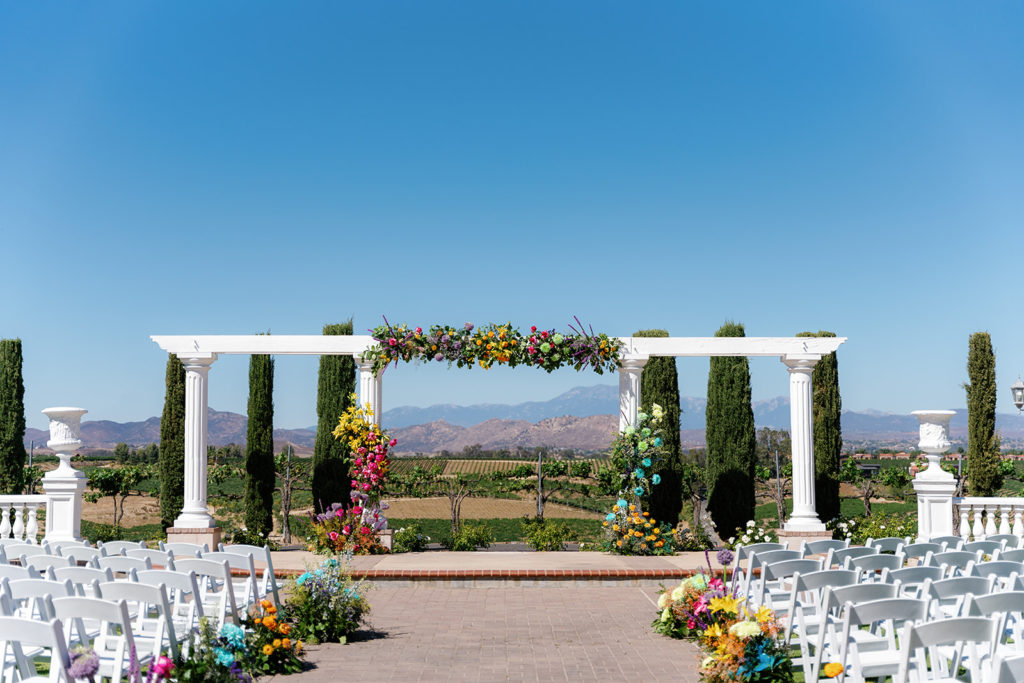 colorful rainbow floral arch for a gay wedding; gay wedding in temecula at mount palomar winery
