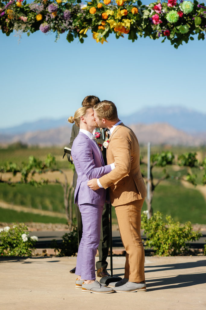 Two grooms kissing at their wedding; gay wedding in temecula at mount palomar winery
