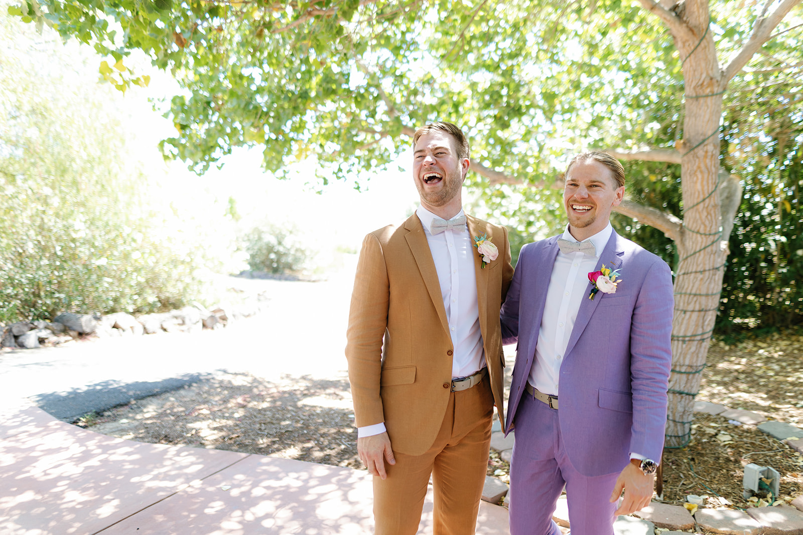 two grooms laughing together on their wedding day; gay wedding in temecula at mount palomar winery