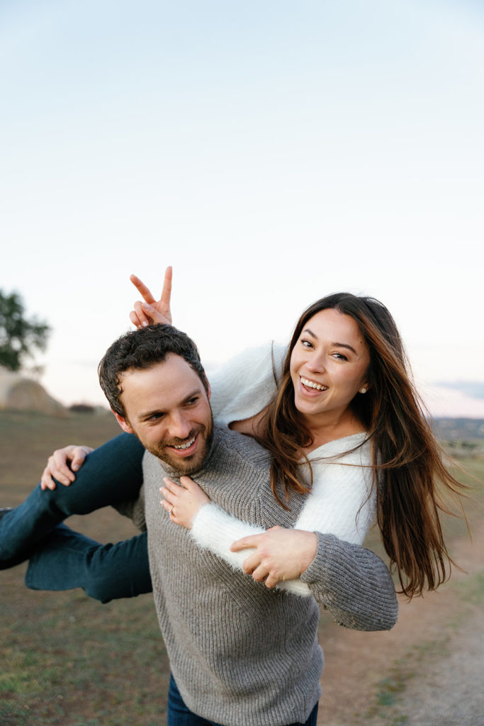 Romantic San Diego Engagement Photos; a woman putting bunny ears on her fiance's head.
