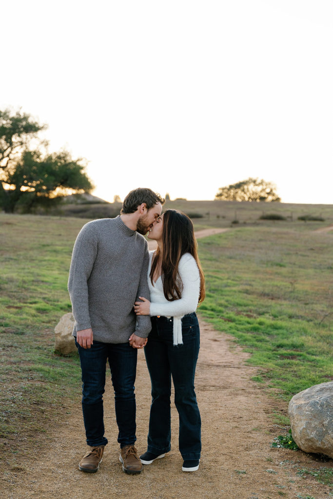 Romantic San Diego Engagement Photos; a man and woman kissing during their engagement photo session.