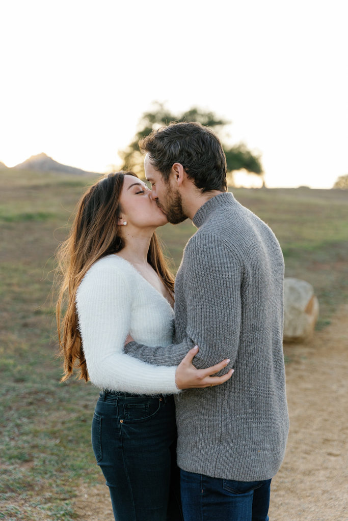 Romantic San Diego Engagement Photos; a man and woman kissing during their engagement photo session.