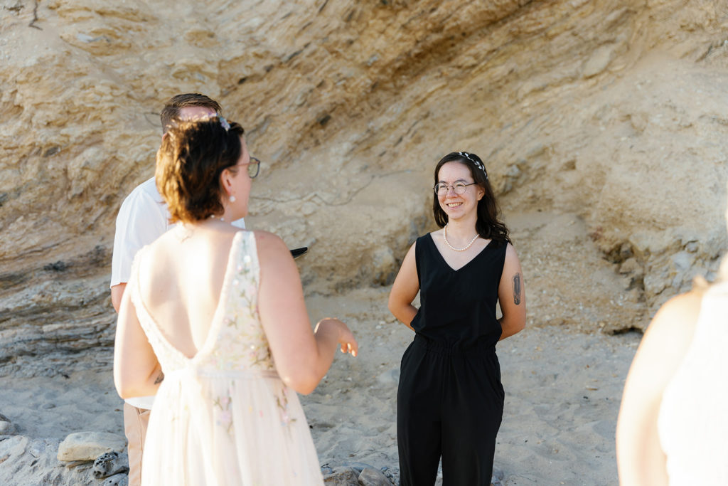 queer wedding photographer in san diego; a non-binary couple reads their vows to each other on their wedding day