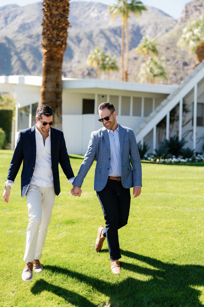 palm springs engagement photos; a gay couple walking hand in hand