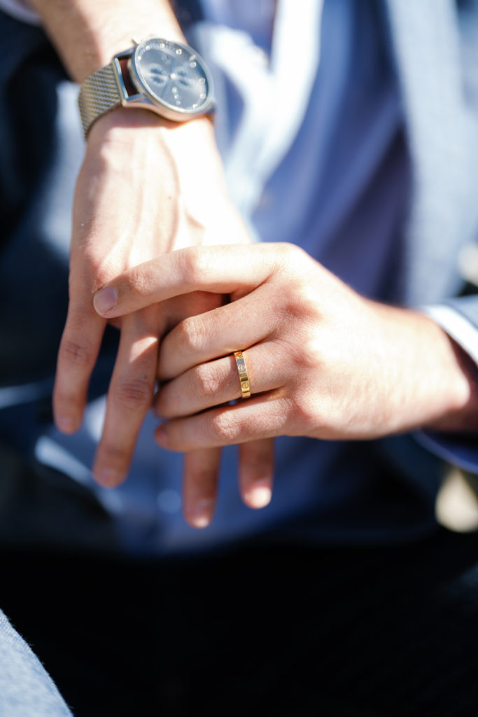 palm springs engagement photos; a gay couple showing off a cartier engagement ring