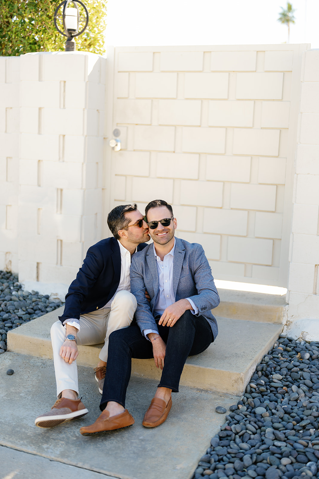 queer wedding photographer in san diego; two men during their engagement session, one is kissing the other on the cheek