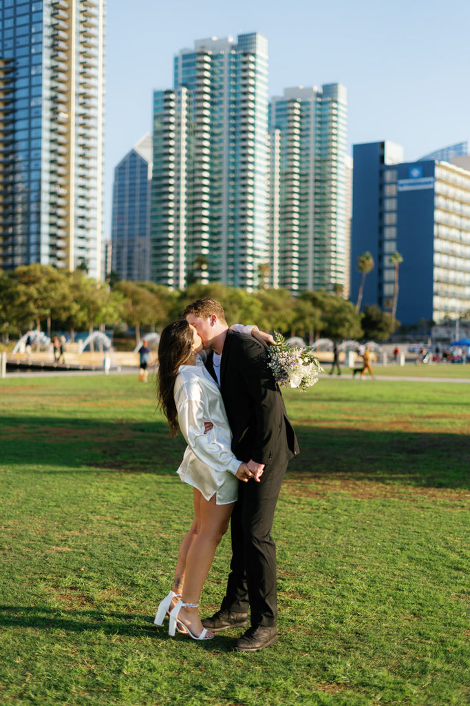 waterfront park engagement photos in san diego; a couple kisses during their engagement session
