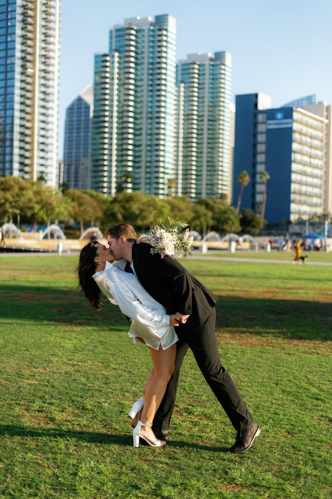 waterfront park engagement photos in san diego; a couple kisses during their engagement session