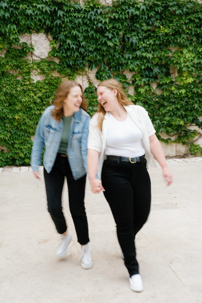 lgbtq museum proposal getty center; a blurry photo of a newly engaged lgbtq couple walking and smiling